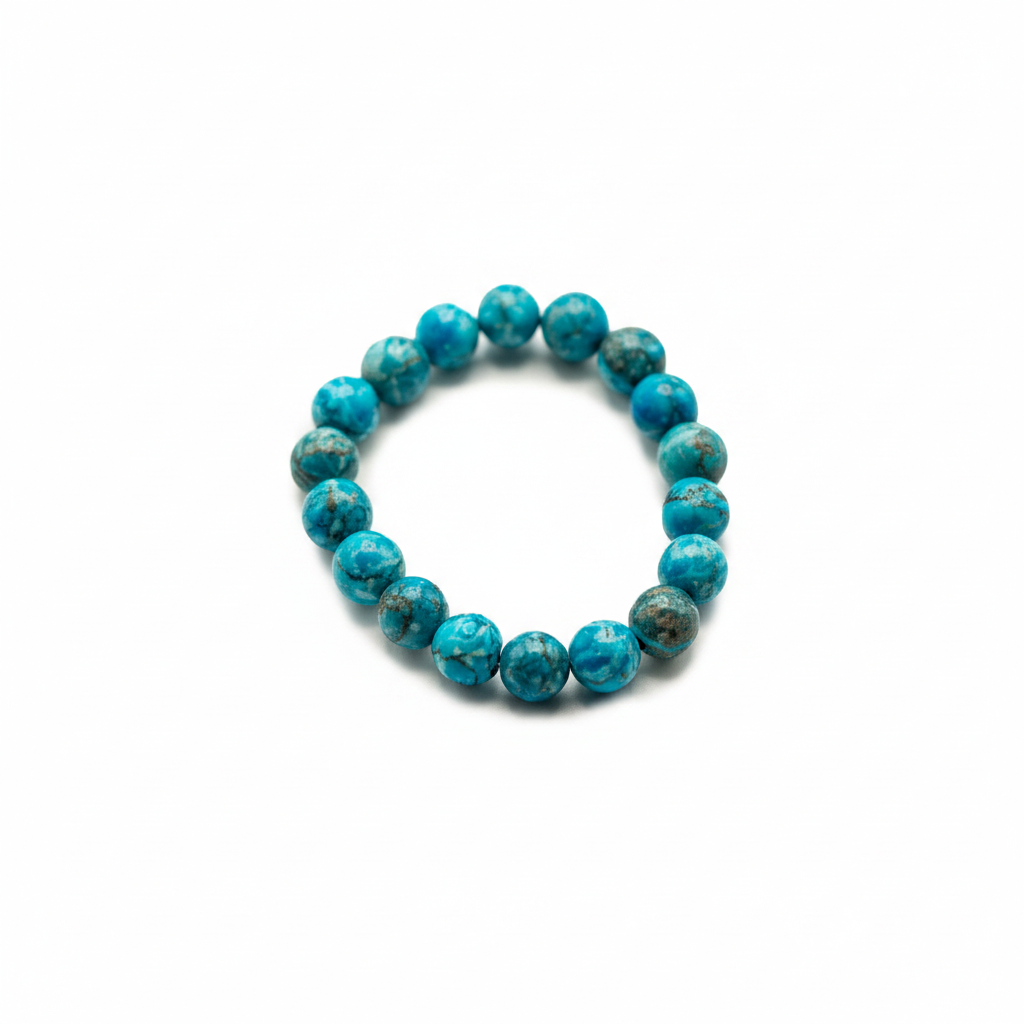 A beaded stretch bracelet made of round turquoise-blue stone beads with dark matrix, photographed on a plain white background.